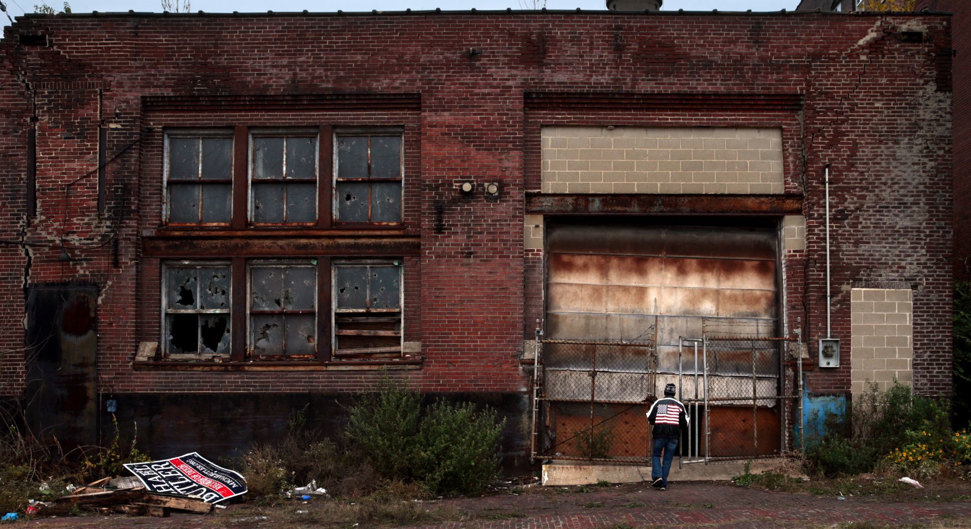 Tents rise under roof of shuttered auto repair shop